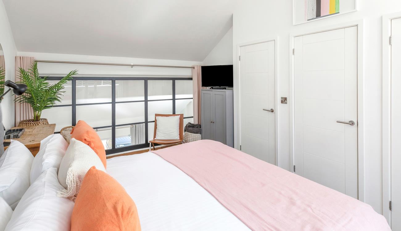 The bedroom has soft sheets and plump pillows for a relaxing night's sleep.