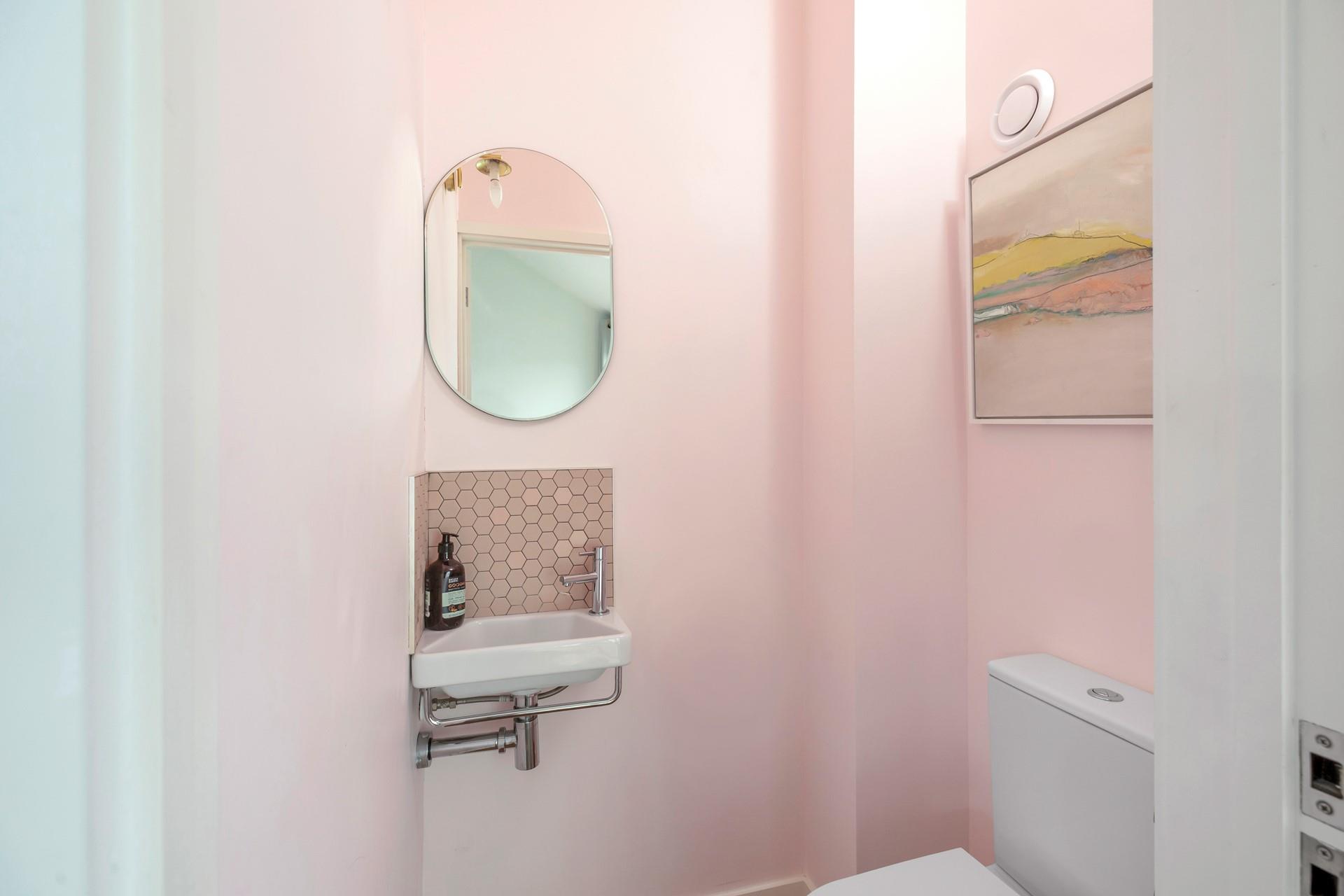 The handy cloakroom decorated in subtle hues.