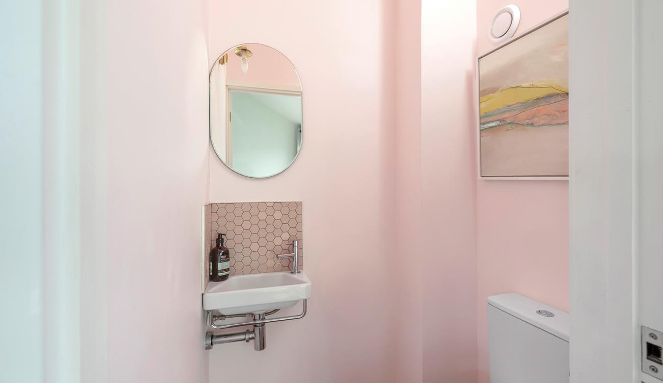 The handy cloakroom decorated in subtle hues.