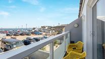 From the living area, the front balcony has sea views.