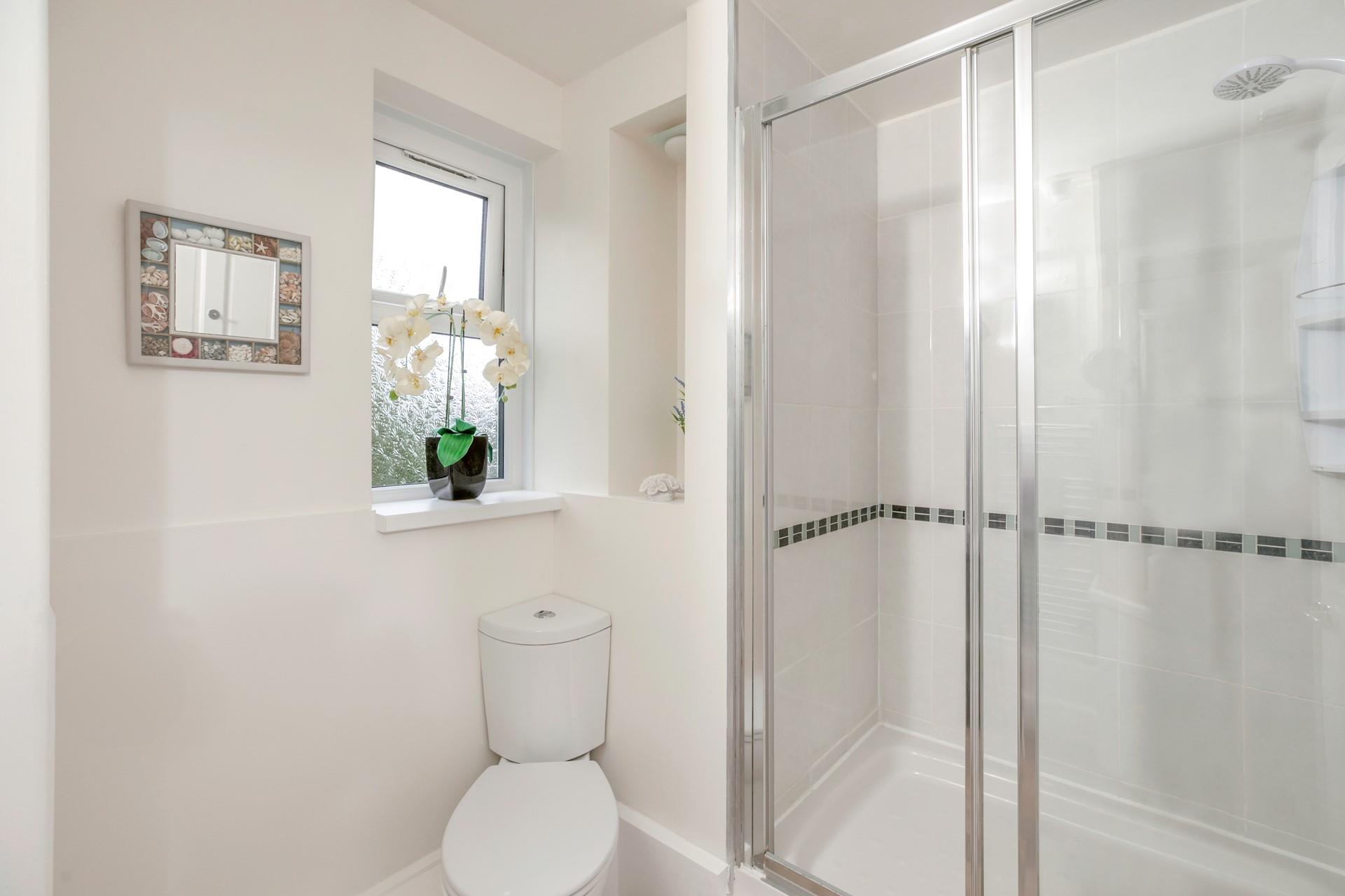The family bathroom has a large walk-in rainfall shower.