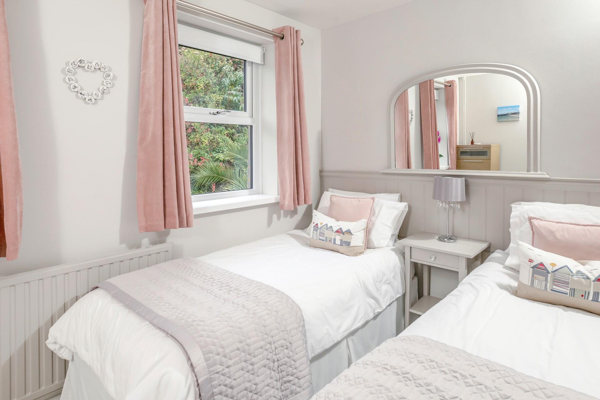 The twin bedroom is a serene space for both children and adults alike.