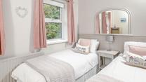The twin bedroom is a serene space for both children and adults alike.