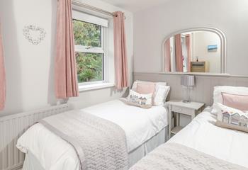 The twin bedroom is a serene space for both children and adults alike.