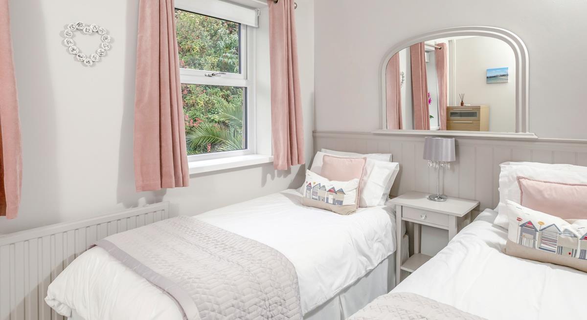 The twin bedroom is a serene space for both children and adults alike.