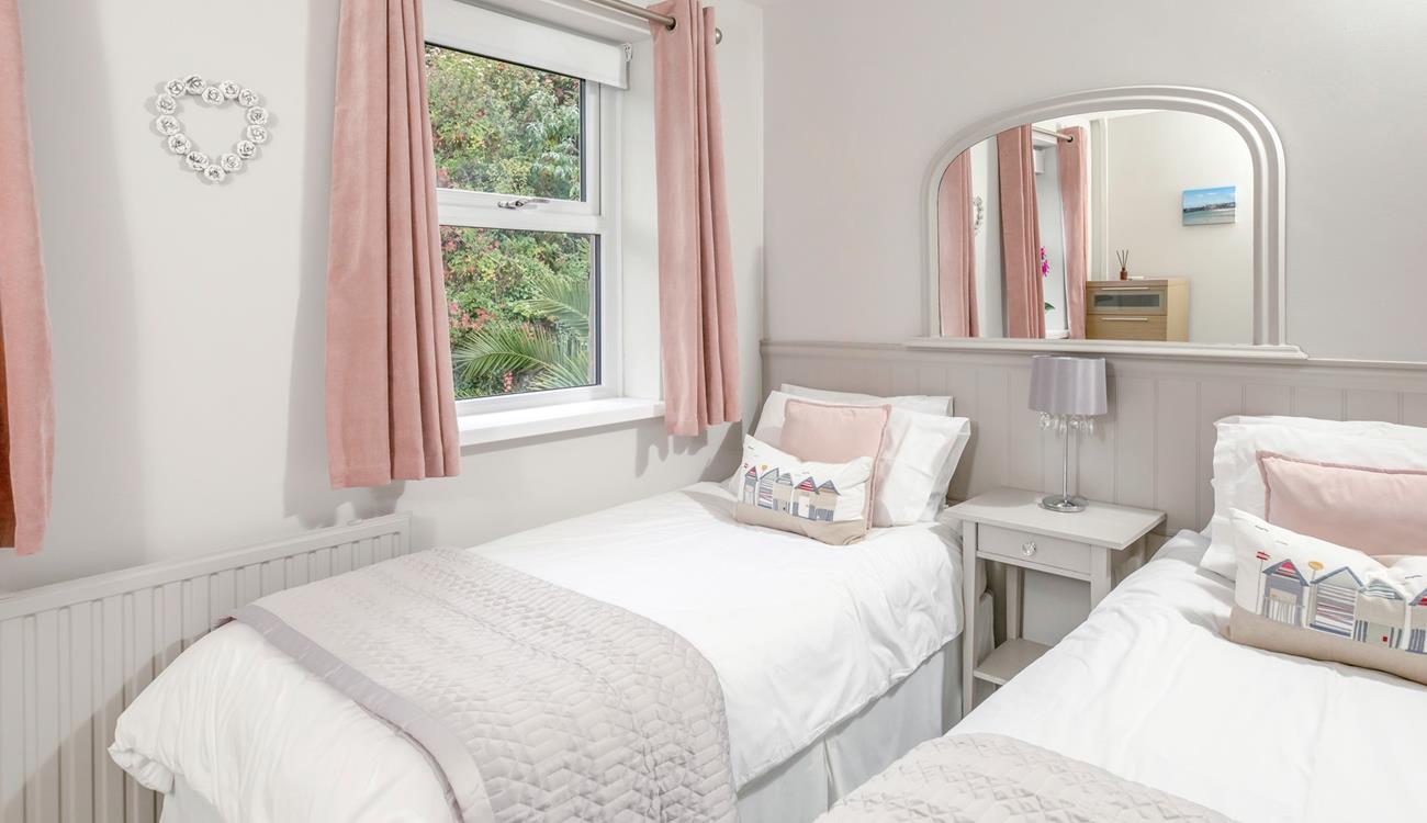 The twin bedroom is a serene space for both children and adults alike.