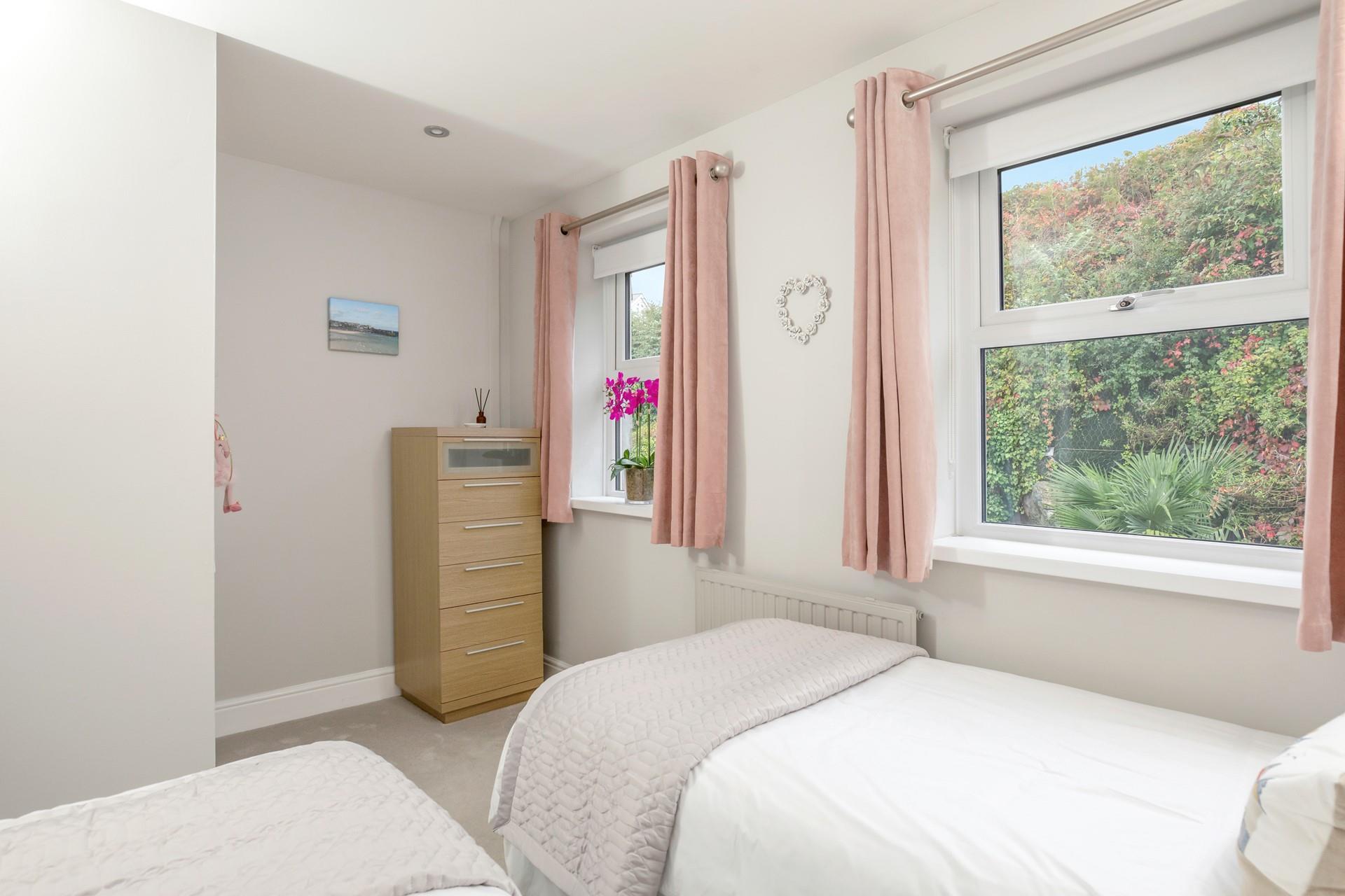 Light and bright, the twin bedroom is a peaceful sanctuary.