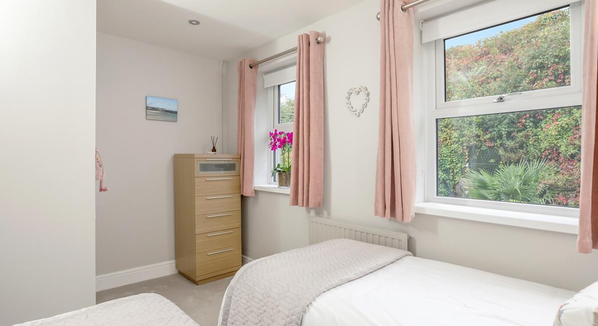 Light and bright, the twin bedroom is a peaceful sanctuary.