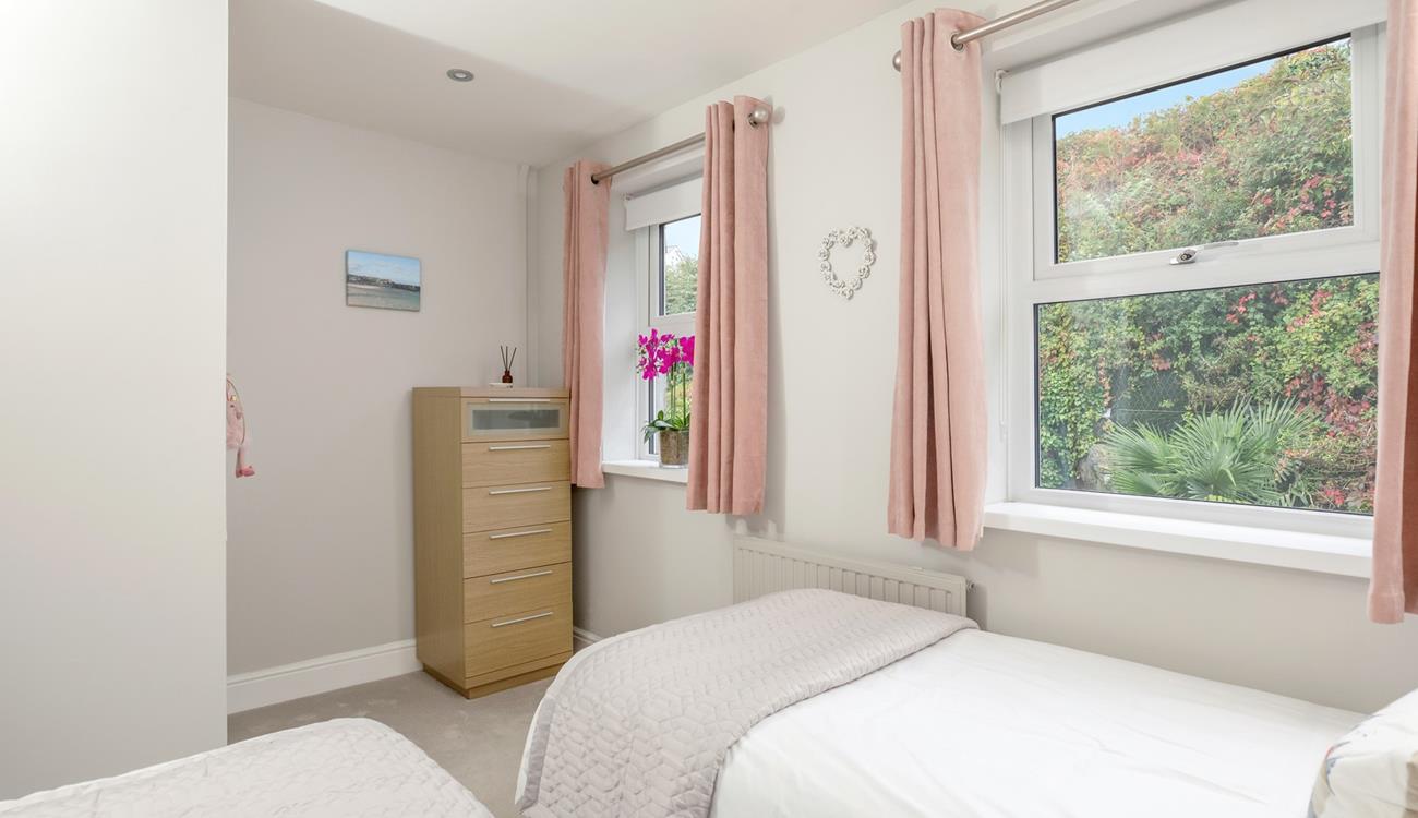 Light and bright, the twin bedroom is a peaceful sanctuary.