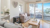 Admire the views from the balcony and the comfortable living area.