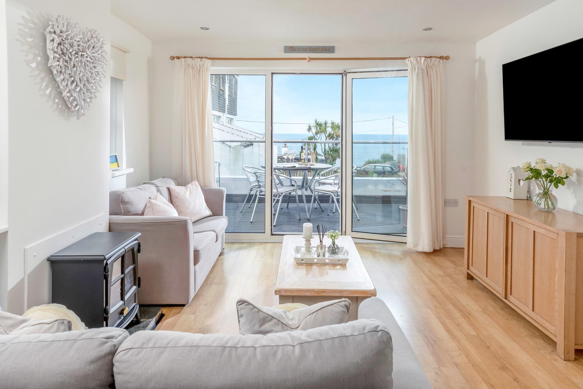 Step from the living area onto the sea-facing balcony.