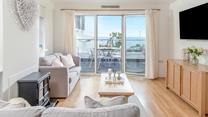 Step from the living area onto the sea-facing balcony.