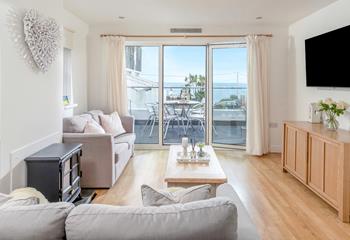 Step from the living area onto the sea-facing balcony.