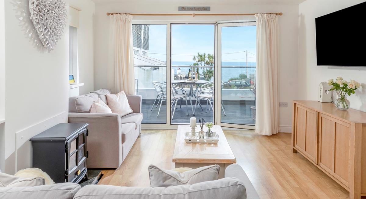 Step from the living area onto the sea-facing balcony.