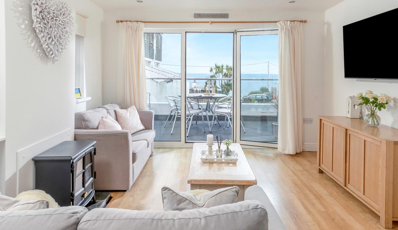 Step from the living area onto the sea-facing balcony.