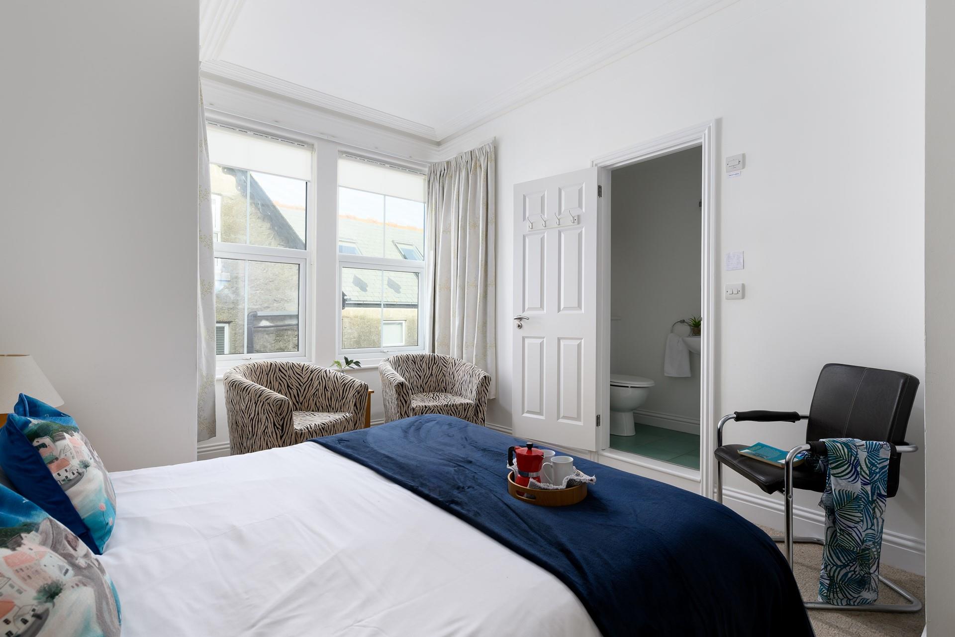 Bedroom 1 has a colourful king size bed and provides a cosy night's sleep.