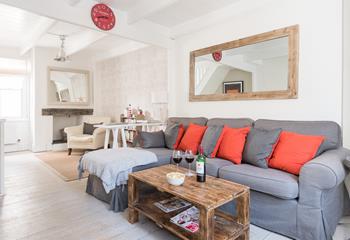 The cosy sitting room has bright pops of colour and is the perfect space to relax after a busy day.