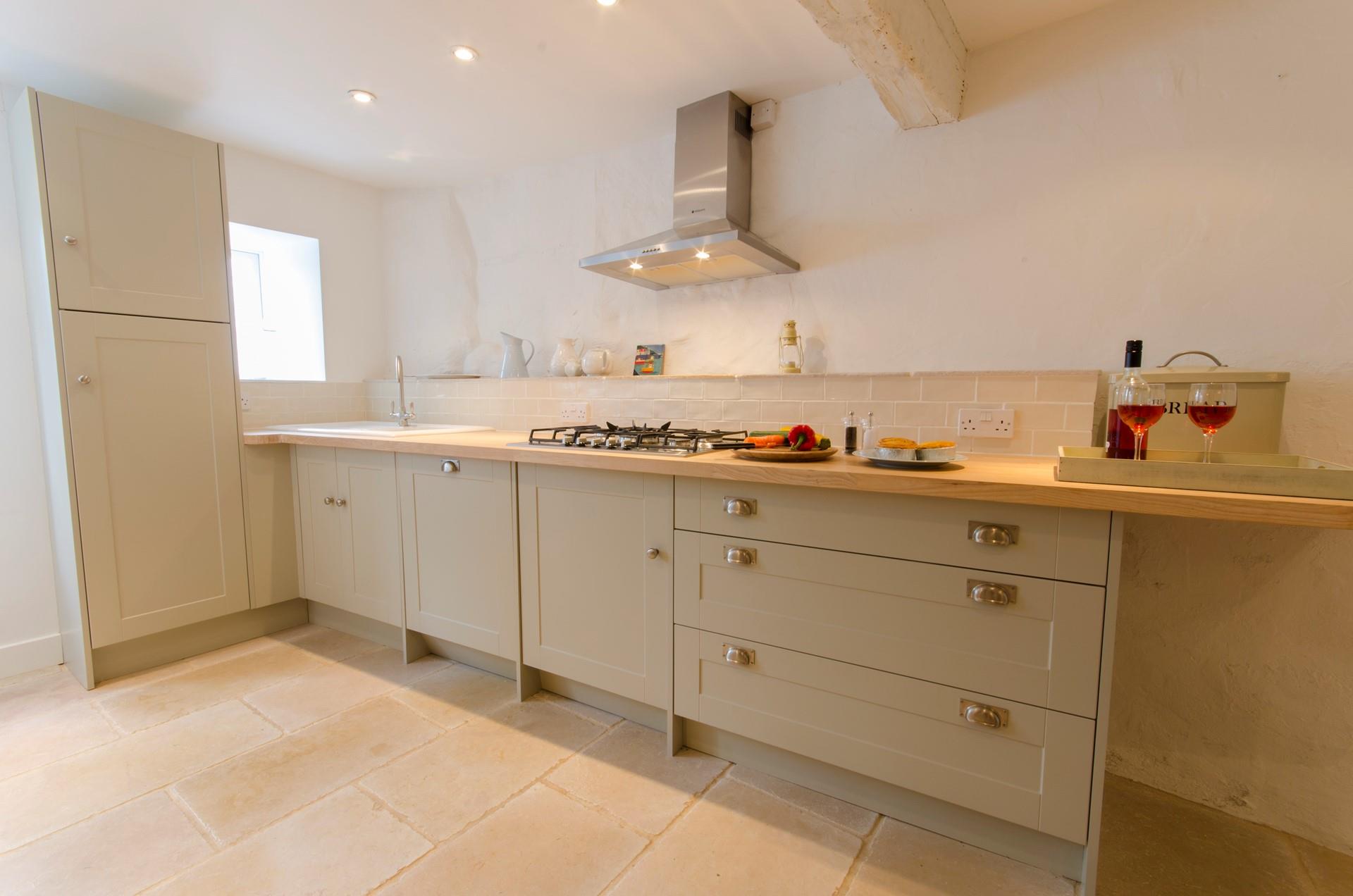 The kitchen has traditional features such as exposed beams and is a lovely space to cook.