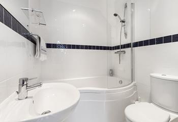 The bathroom benefits from both a bath with shower, perfect for a bubbly soak after a day stomping the coastal paths.