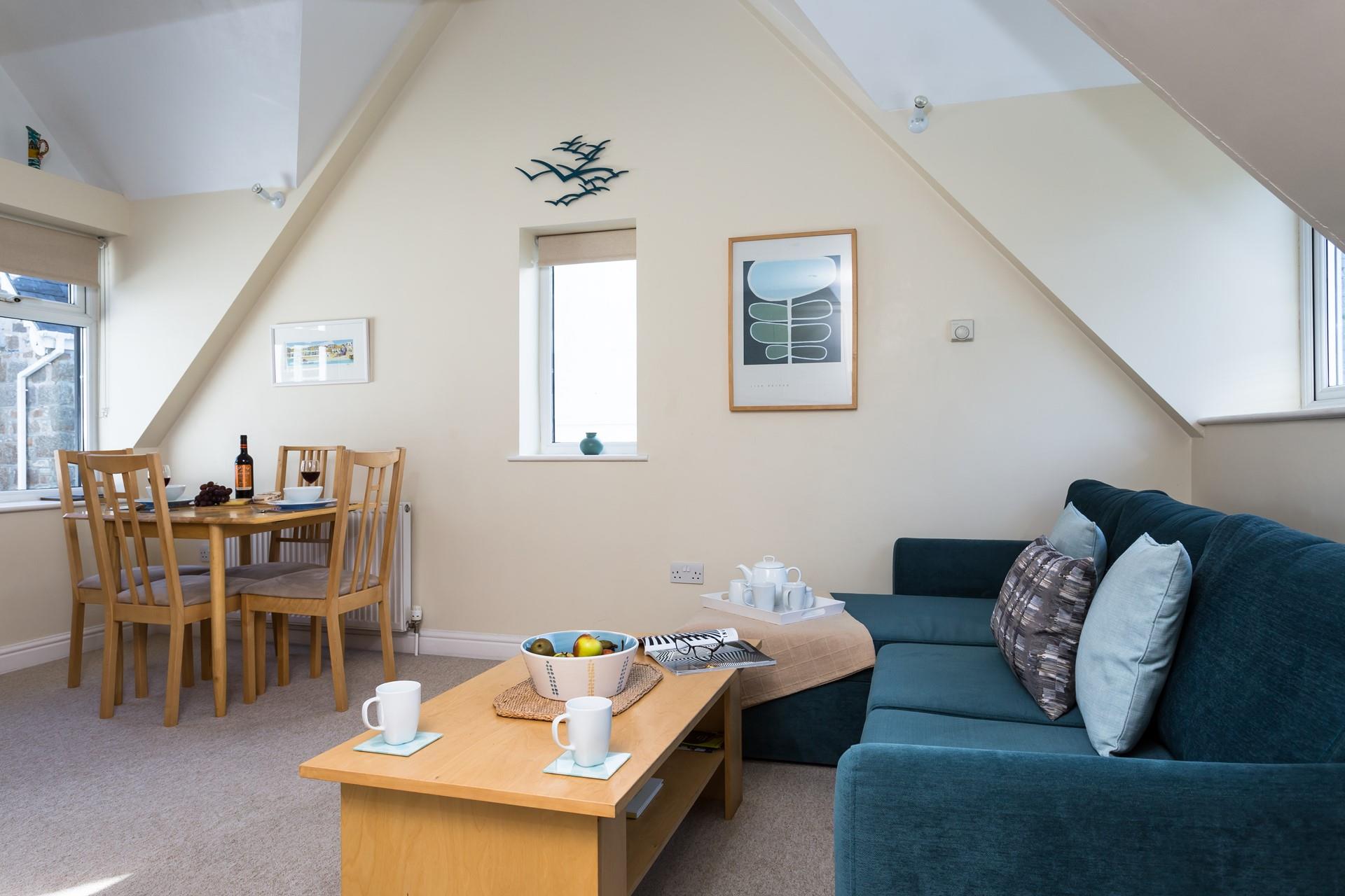 The cosy corner sofa offers plenty of room to snuggle up with a glass of wine in hand.