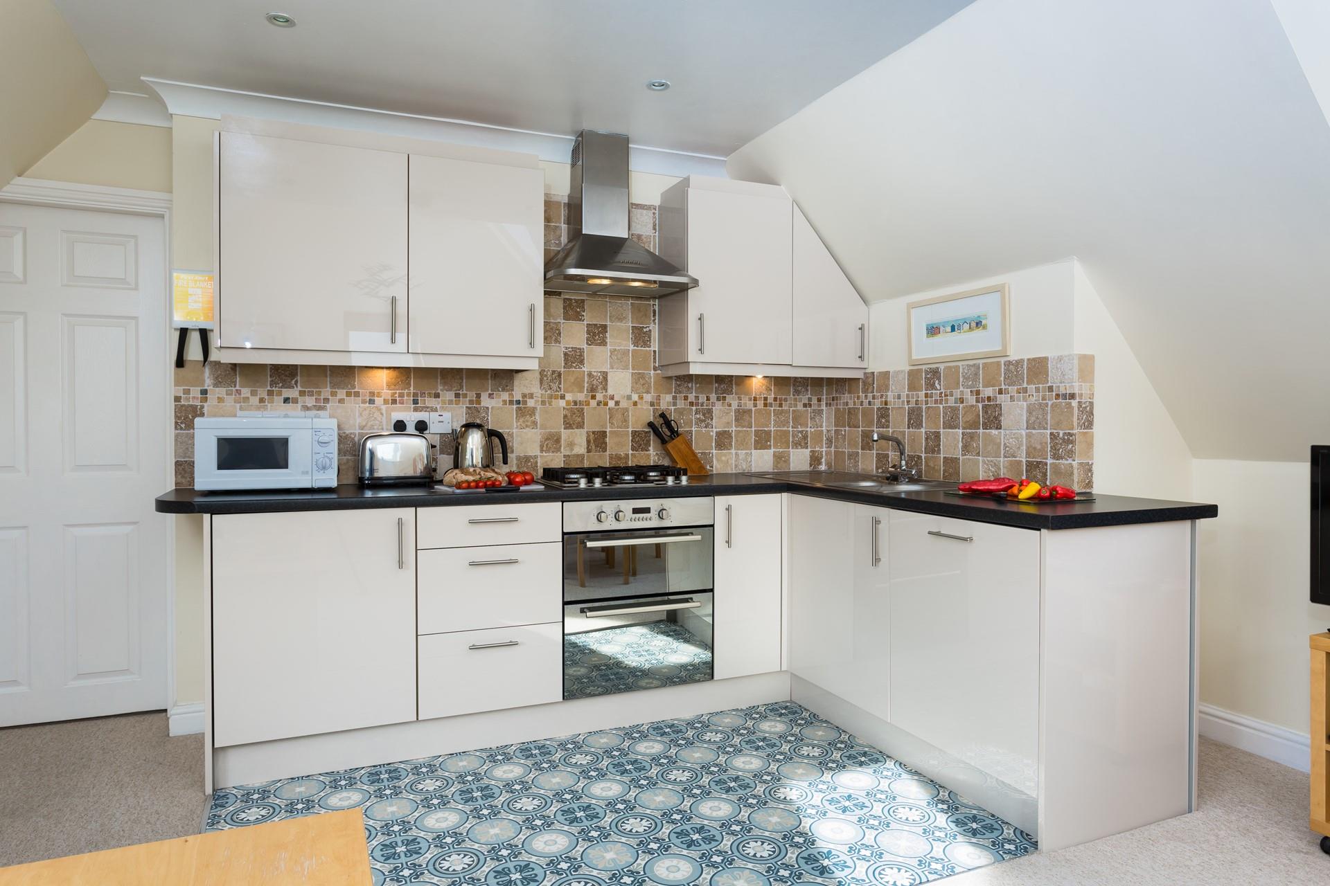 The kitchen is modern with plenty of appliances to make cooking up delicious meals a breeze.