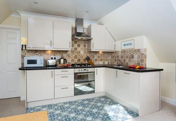 The kitchen is modern with plenty of appliances to make cooking up delicious meals a breeze.