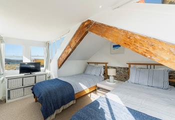 Original beams create character and charm in this cosy bedroom.
