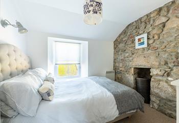 The exposed wall gives the bedroom a lovely cosy cottage feel.