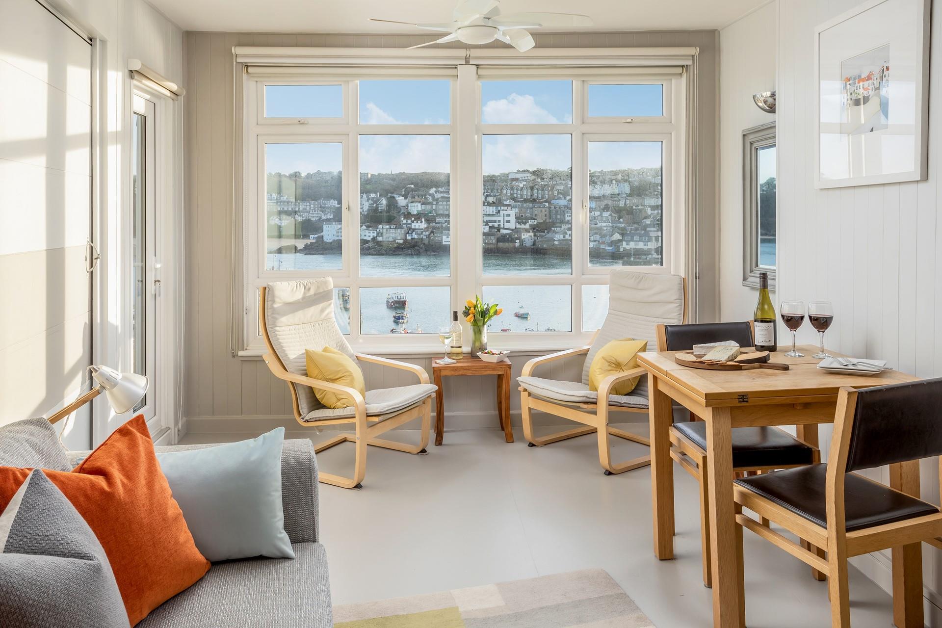 The sitting room boasts fantastic harbour views through the beautiful windows. 