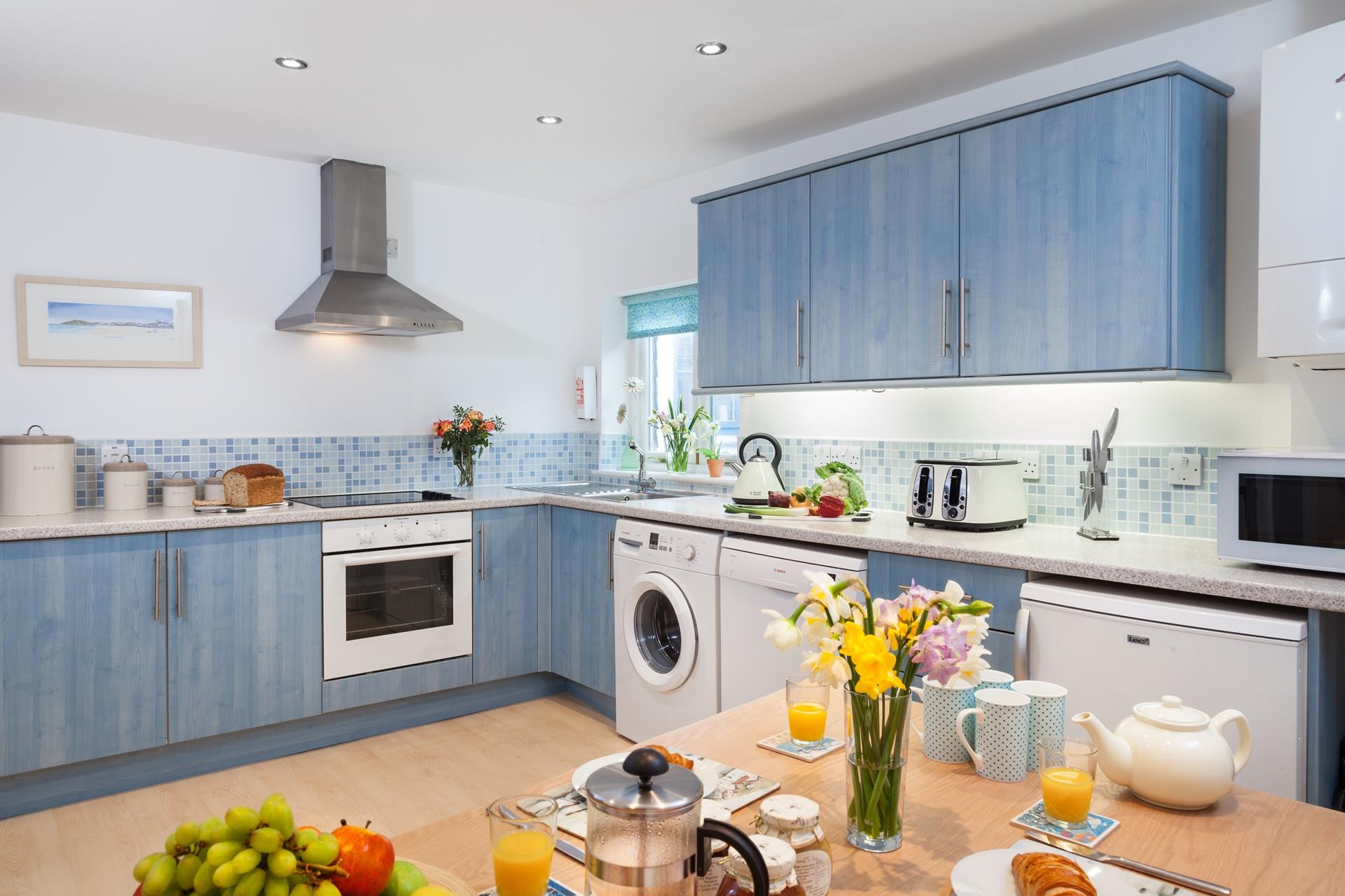 The unique kitchen has a stunning blue theme, reminding you just how close to the sea you are.