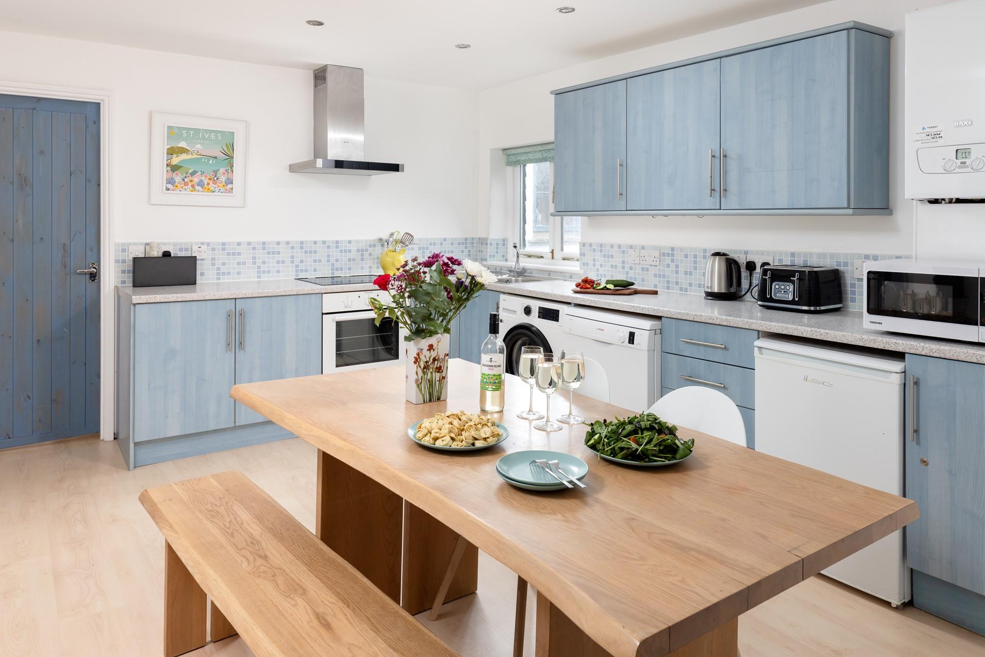 Cornish-themed artwork is dotted around the pretty cottage.