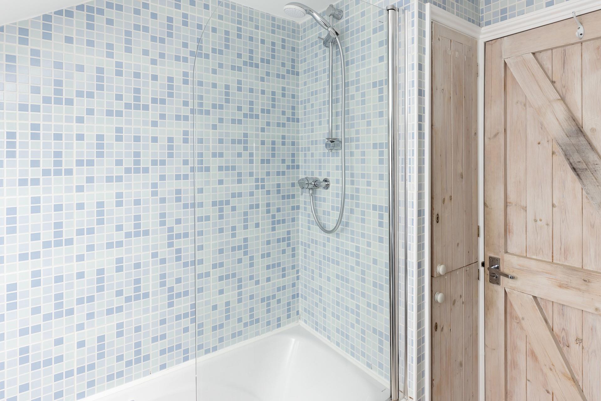 The bathroom benefits from a shower and bath!