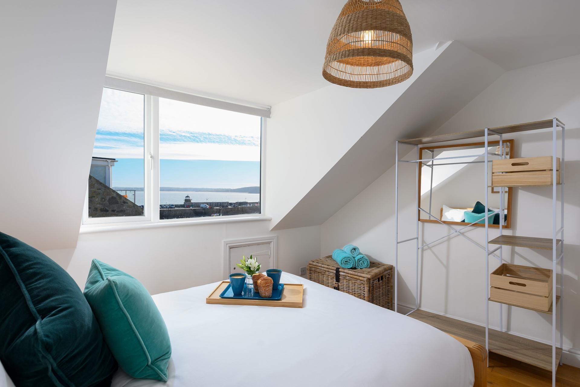 This bedroom benefits from harbour views, allowing you to wake up and enjoy some time wave watching.