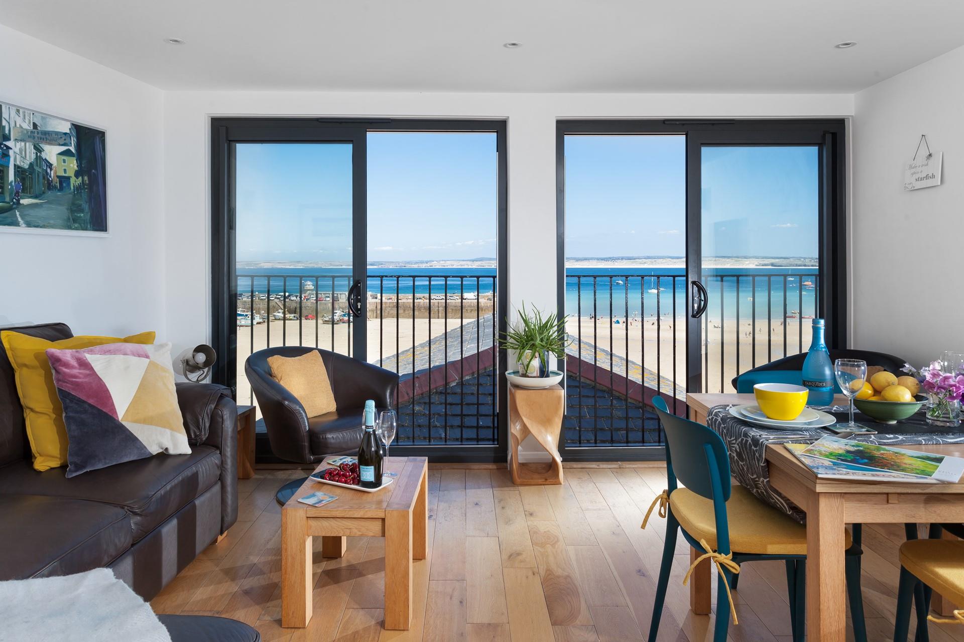 The floor to ceiling windows and stylish modern armchairs allow you to make the most of the stunning views.