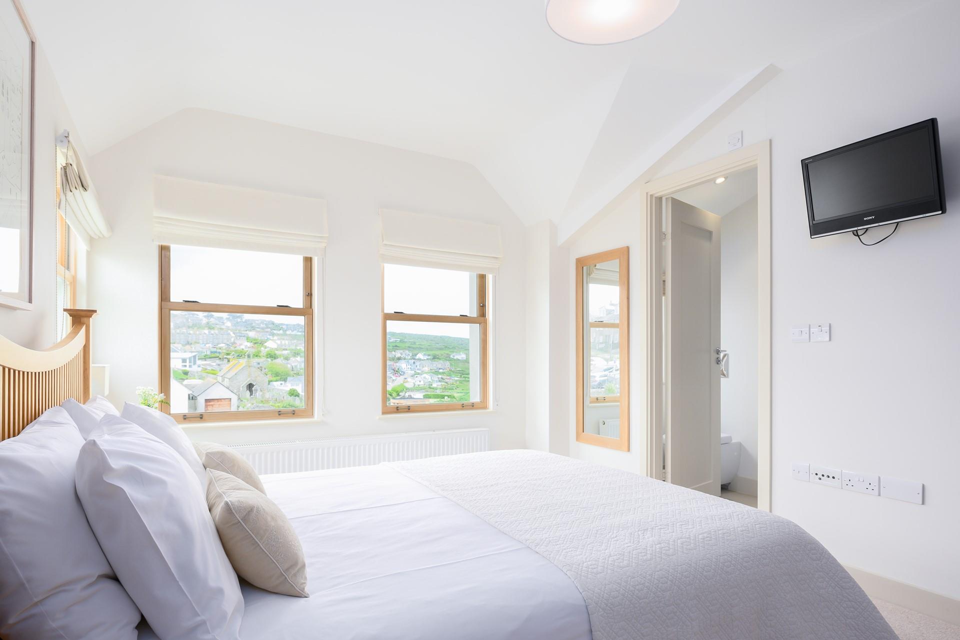 Bedroom 1 has an en suite and views towards to sea.