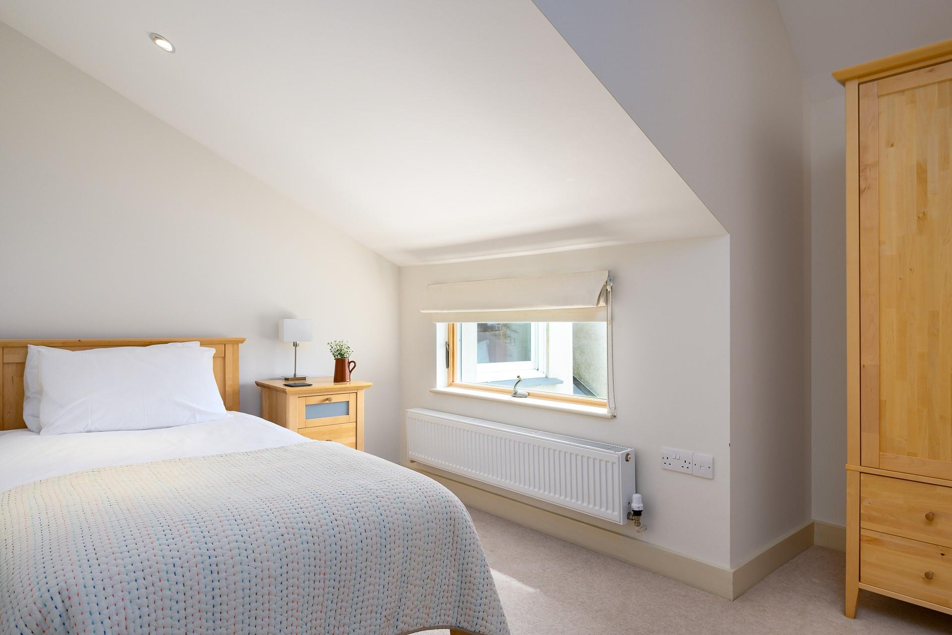 Bedroom 2 has twin beds and lovely wooden furnishings.