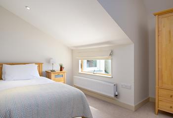 Bedroom 2 has twin beds and lovely wooden furnishings.