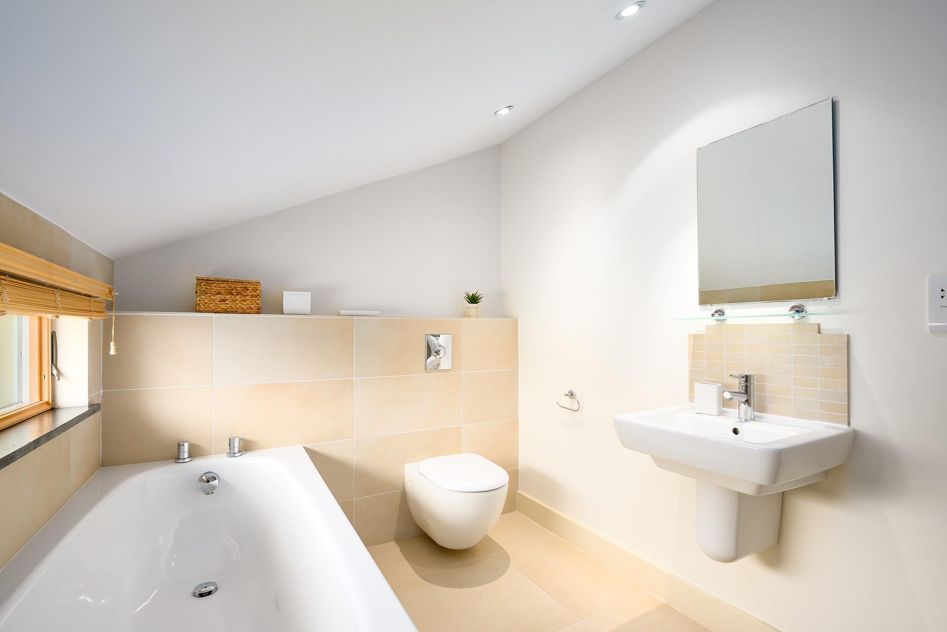 The family bathroom has a bath to relax after a day walking the coast path.