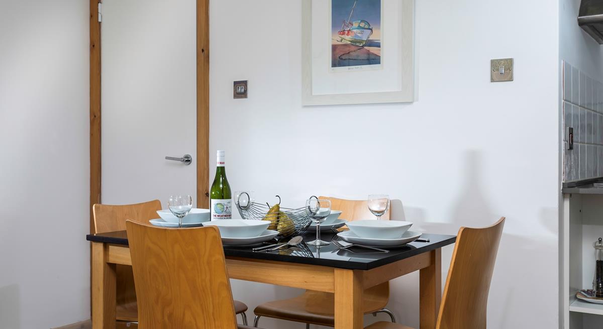 The dining table is ideally placed to converse with the dedicated chef!