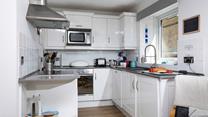 The open plan kitchen is bright and practical.