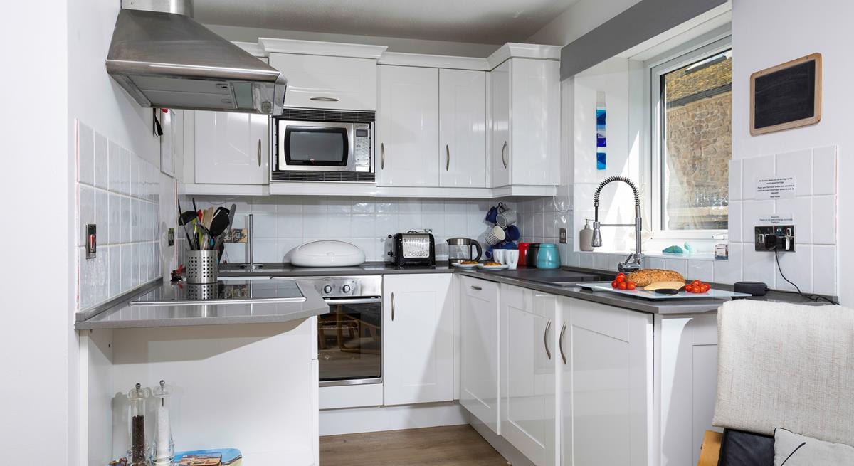 The open plan kitchen is bright and practical.