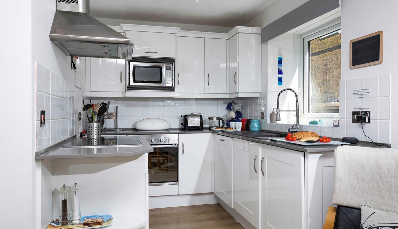The open plan kitchen is bright and practical.