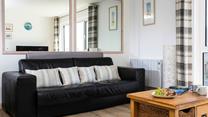 The sofa in the sitting room converts into a bed, with ample space to make yourselves comfortable. 