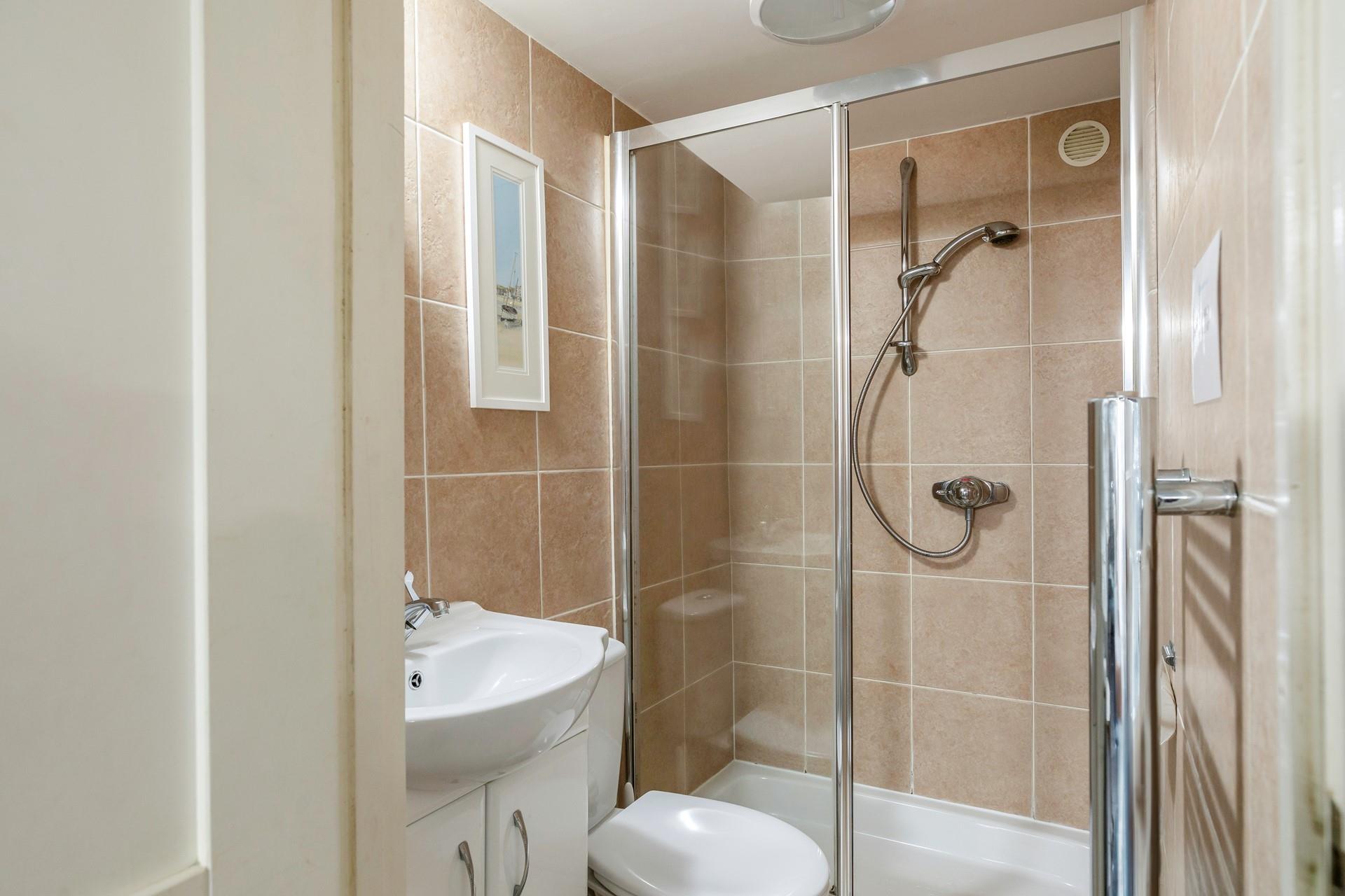 The shower room has a double walk-in shower, perfect for washing away the sand after a day lounging on the beach!