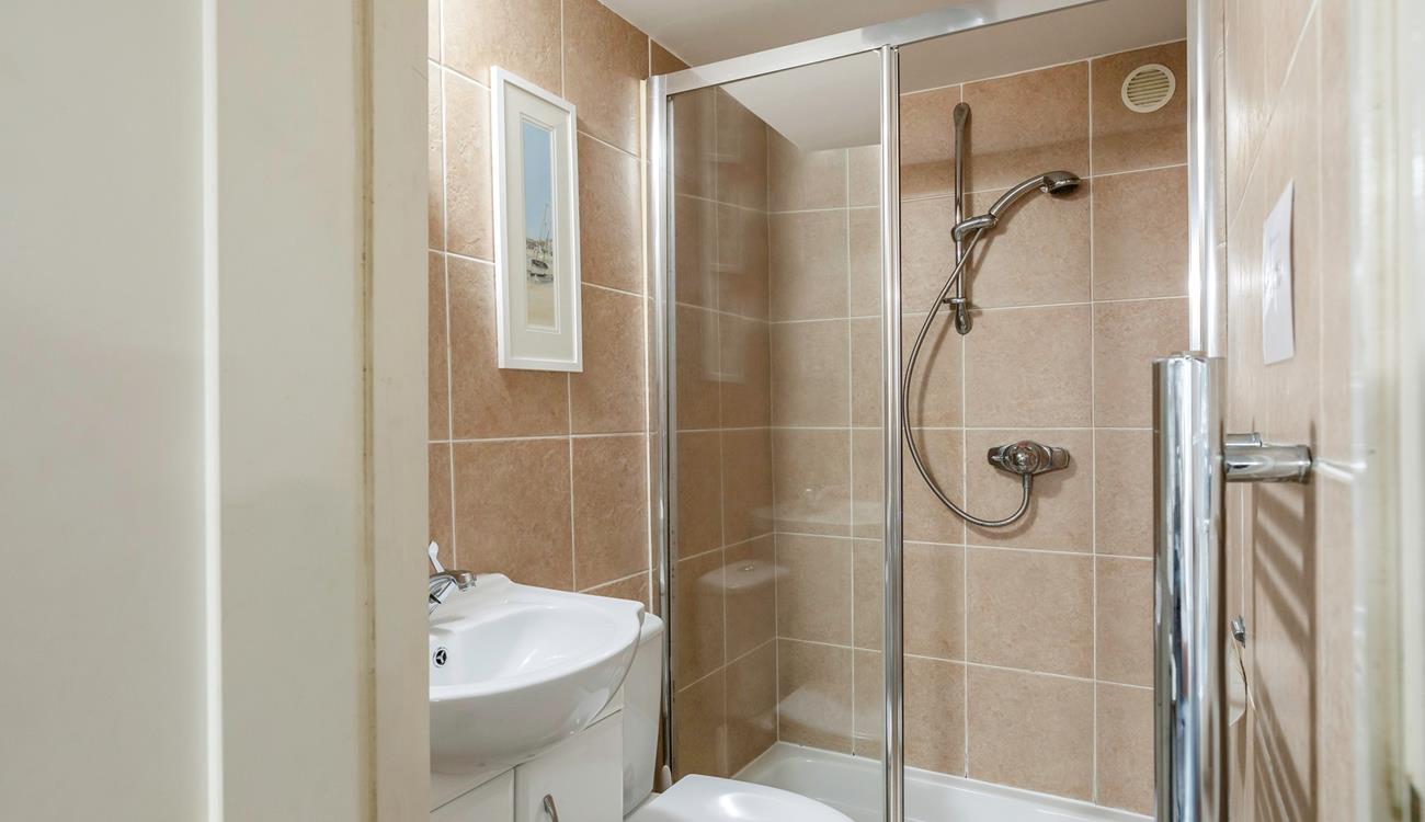 The shower room has a double walk-in shower, perfect for washing away the sand after a day lounging on the beach!