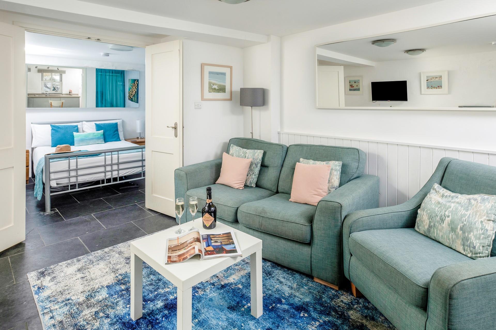 The cosy and beautifully styled living area is a lovely place to relax. 