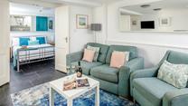 The cosy and beautifully styled living area is a lovely place to relax. 