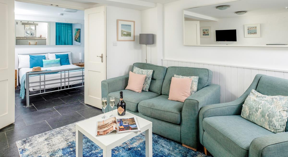 The cosy and beautifully styled living area is a lovely place to relax. 