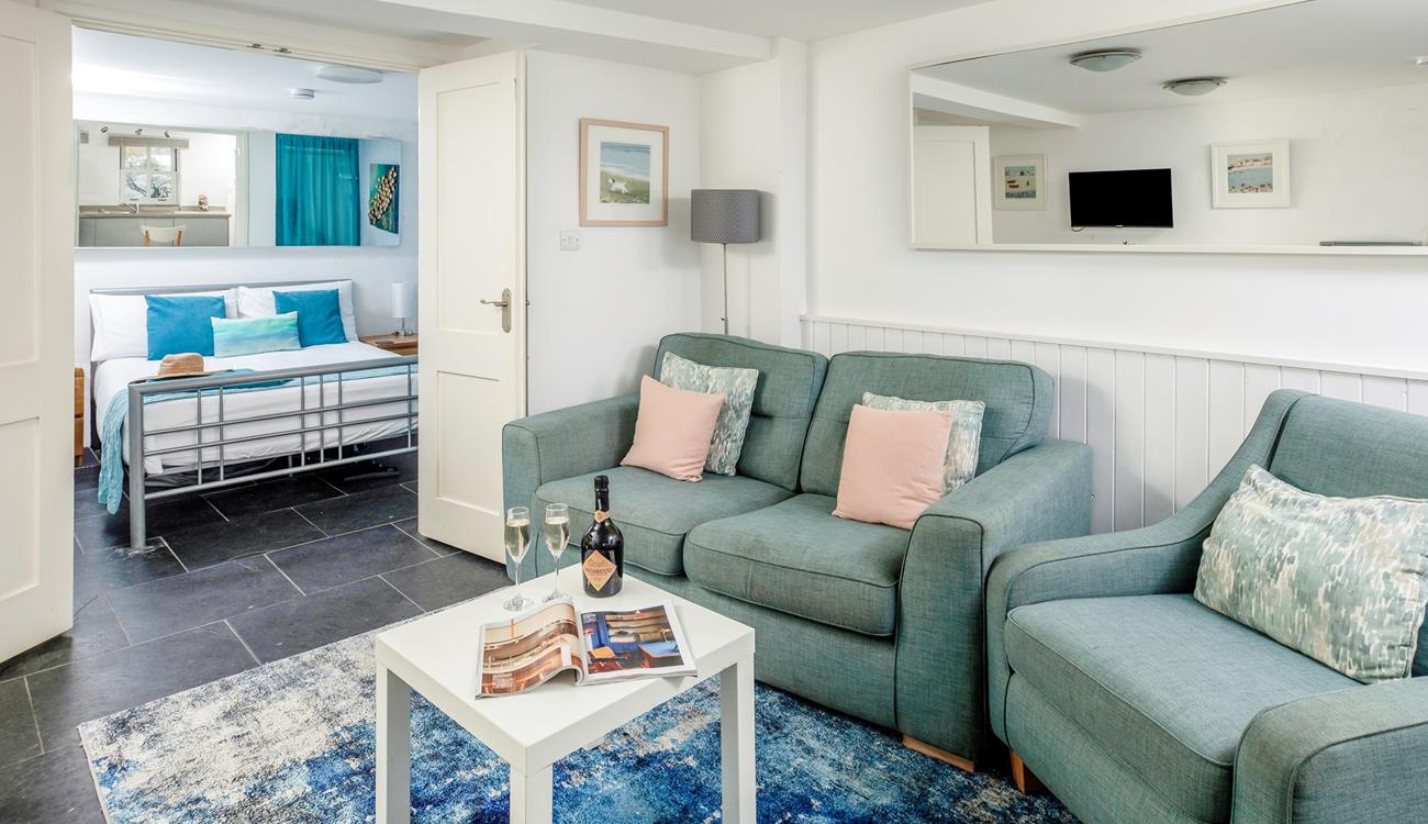 The cosy and beautifully styled living area is a lovely place to relax. 