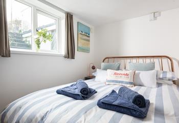 The cosy double bed is the perfect base to come back to after a day at the beach.